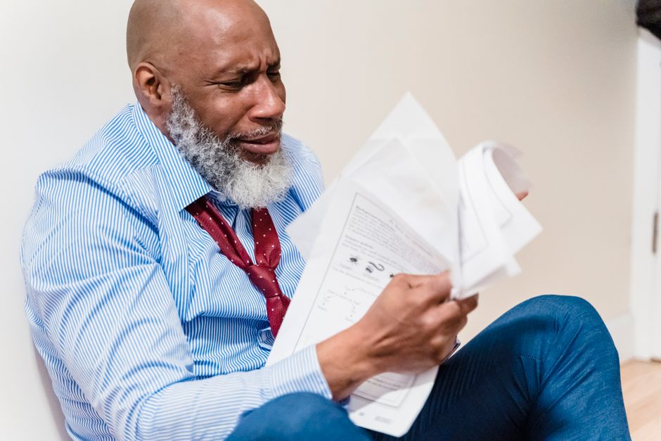 scientist reviewing documents corporate boardroom pressure